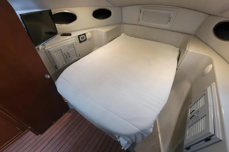 Slide: The Image of Cozy cabin interior of a 1992 Mediterranean 38 yacht with a neatly made bed. - 5