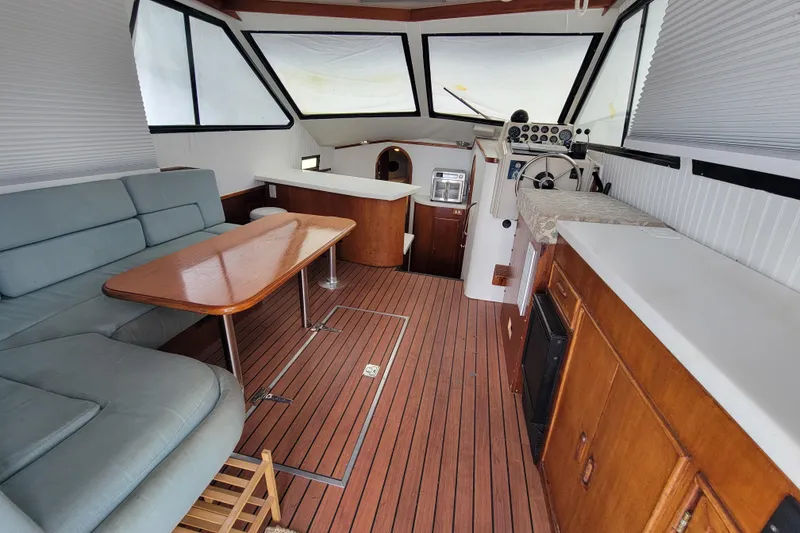 Slide: The Image of Interior of a 1992 Mediterranean 38 boat with wood flooring and seating area. - 1