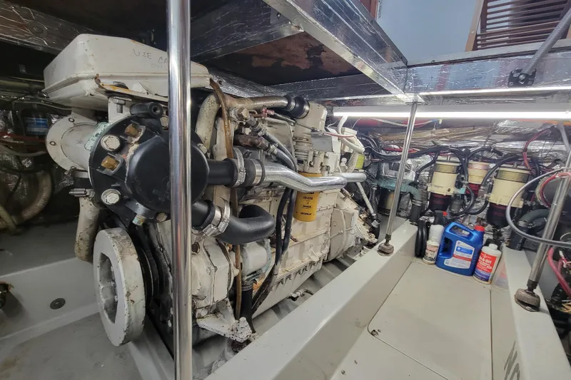 Slide: The Image of Engine room of a 1992 Mediterranean 38 boat with visible machinery and maintenance supplies. - 8