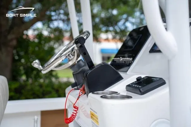 Slide: The Image of 2024 Sea Pro 208 Bay boat console with steering wheel and controls. - 15