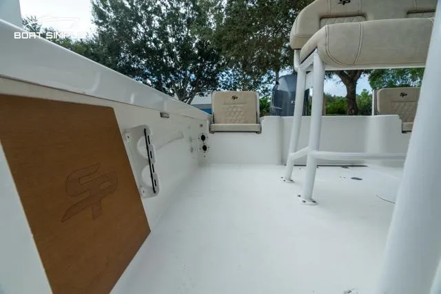 Slide: The Image of 2024 Sea Pro 208 Bay boat interior with seating and console, showcasing modern design. - 21