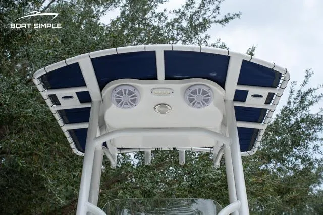 Slide: The Image of 2024 Sea Pro 208 Bay boat T-top with speakers and blue canopy. - 8