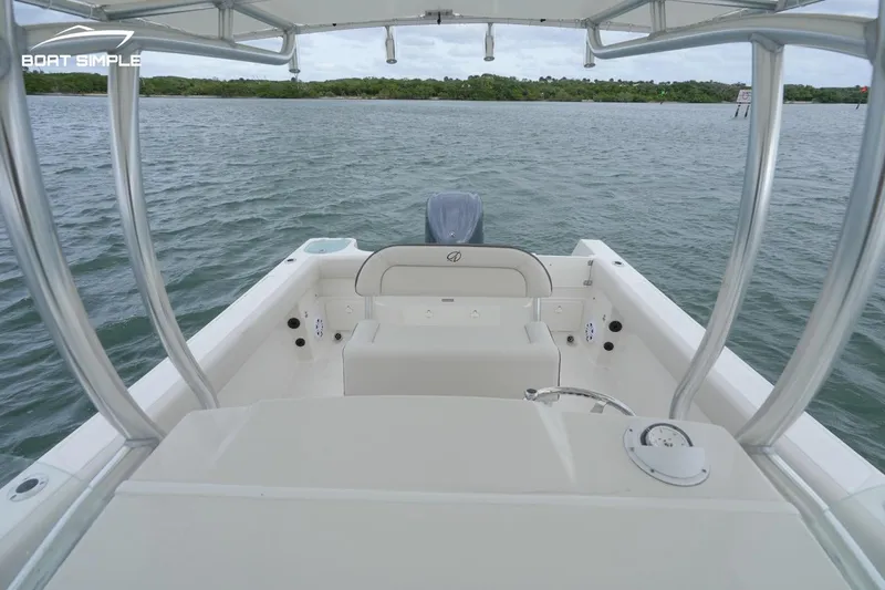 Slide: The Image of 2024 Sailfish 242 CC boat interior with seating, on calm water. - 6