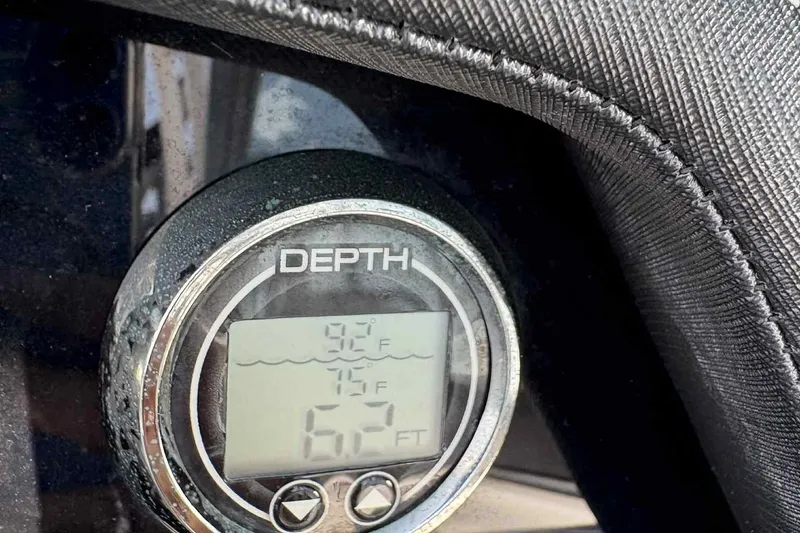 Slide: The Image of Interior of a 2018 Monterey M65 boat, featuring sleek white and black seating. - 16