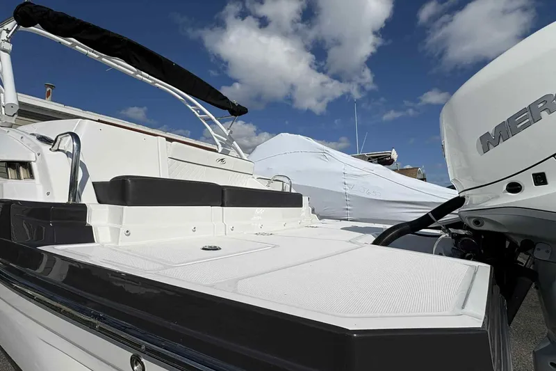 Slide: The Image of Monterey M65 2018 boat with nautical flags on white hull. - 25