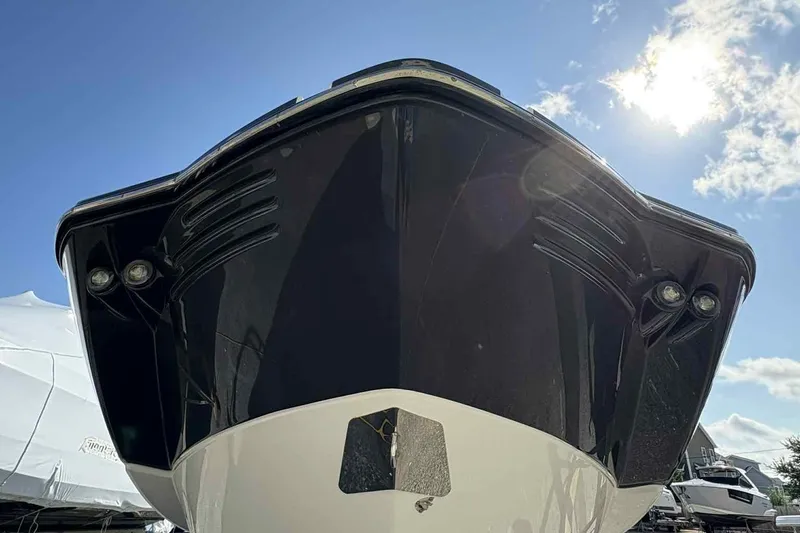 Slide: The Image of Front view of a 2018 Monterey M65 boat under a clear blue sky. - 3
