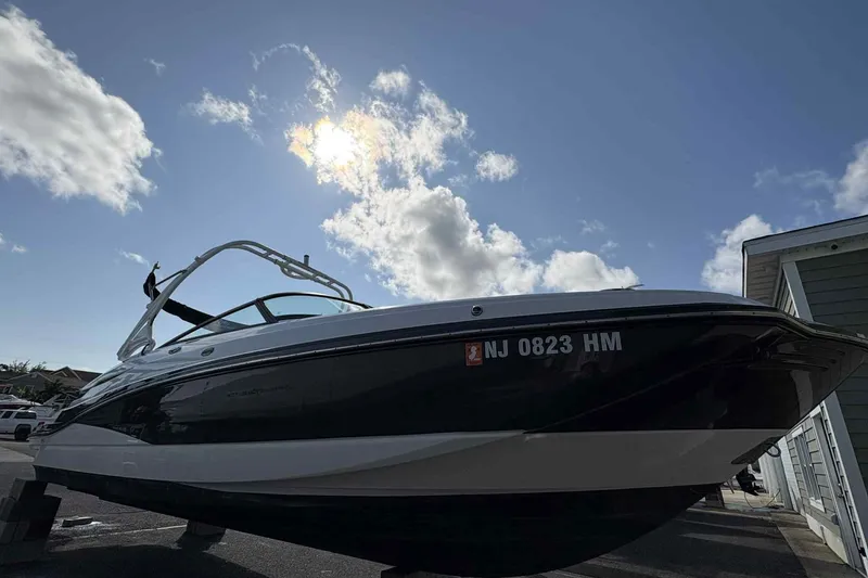 Slide: The Image of 2018 Monterey M65 boat interior with white cushioned seating and diamond stitching. - 5