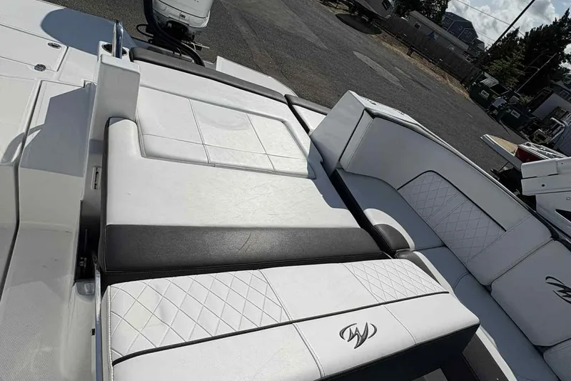 Slide: The Image of Open storage compartment in a 2018 Monterey M65 boat with paddle inside. - 7