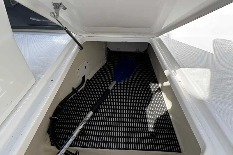 Slide: The Image of 2018 Monterey M65 boat cockpit with steering wheel and dashboard under a cloudy sky. - 9