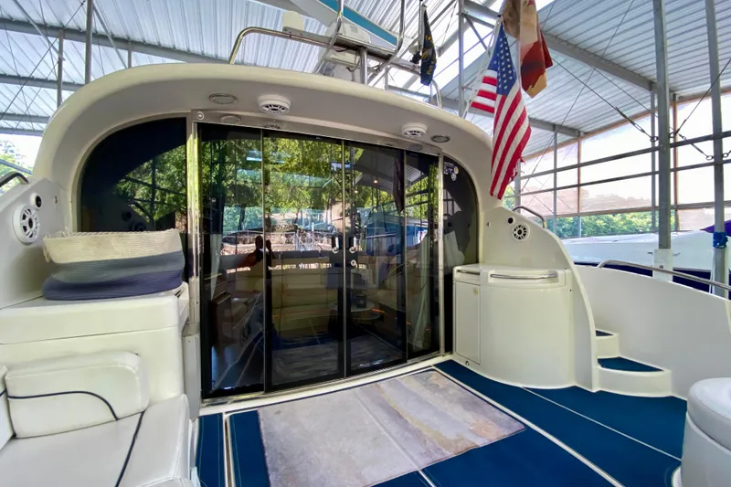 Slide: The Image of 1999 Neptunus 54 Hardtop Express yacht interior with glass doors and American flag. - 18