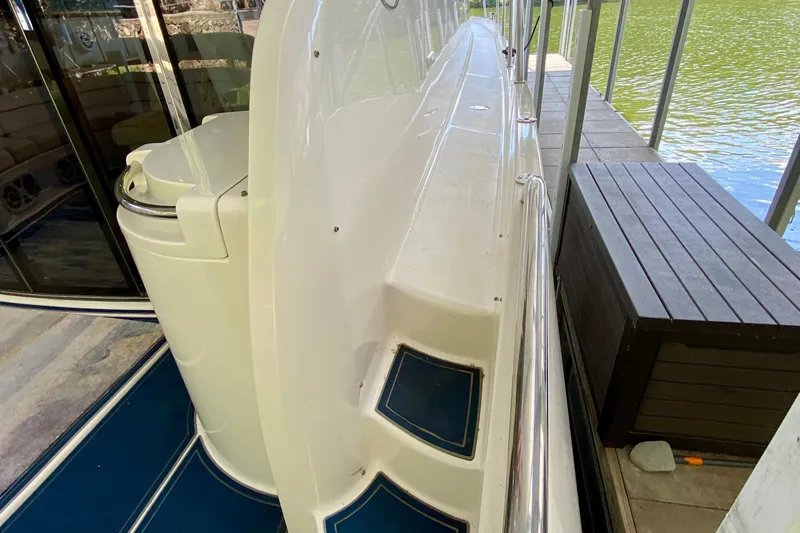 Slide: The Image of 1999 Neptunus 54 Hardtop Express yacht docked, showcasing sleek design and spacious deck area. - 19