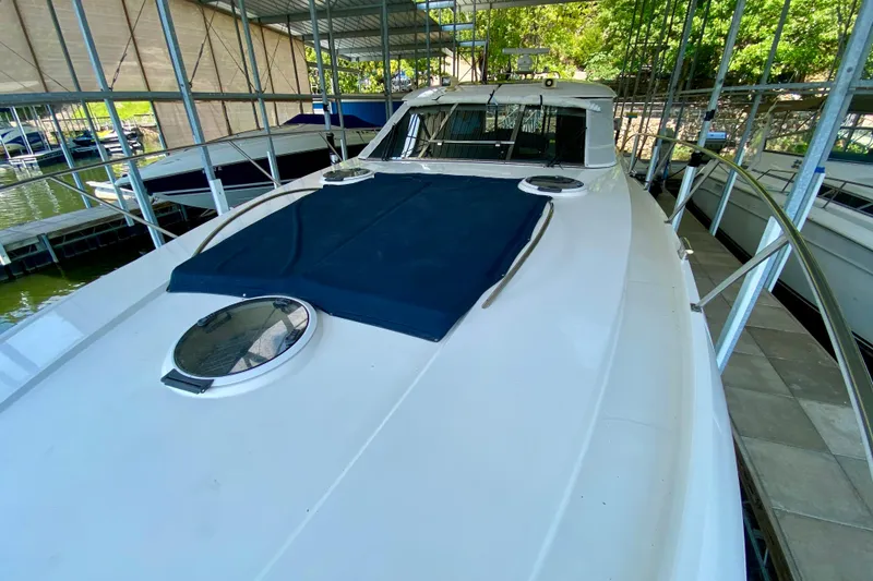 Slide: The Image of 1999 Neptunus 54 Hardtop Express yacht docked in a covered marina. - 23