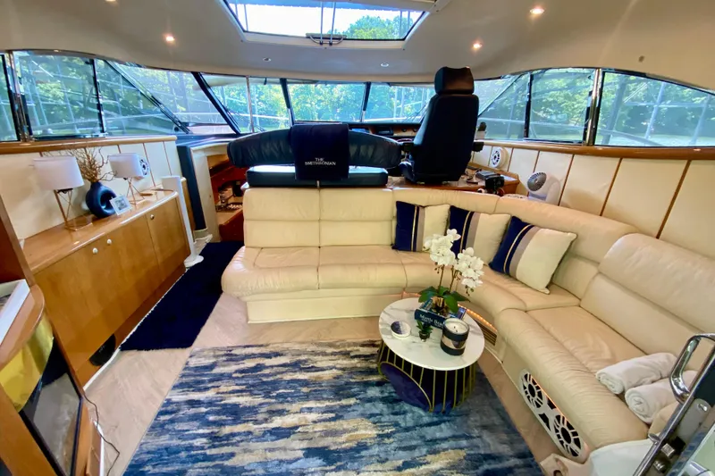 Slide: The Image of Luxurious interior of 1999 Neptunus 54 Hardtop Express yacht with plush seating and elegant decor. - 25
