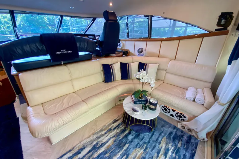 Slide: The Image of Luxurious interior of 1999 Neptunus 54 Hardtop Express yacht with plush seating and decor. - 26