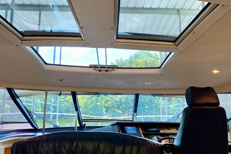 Slide: The Image of Interior view of 1999 Neptunus 54 Hardtop Express yacht with sunroof and helm. - 33