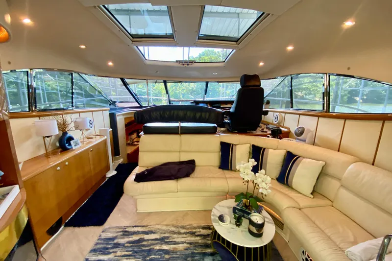 Slide: The Image of Luxurious interior of 1999 Neptunus 54 Hardtop Express yacht with plush seating and elegant decor. - 34