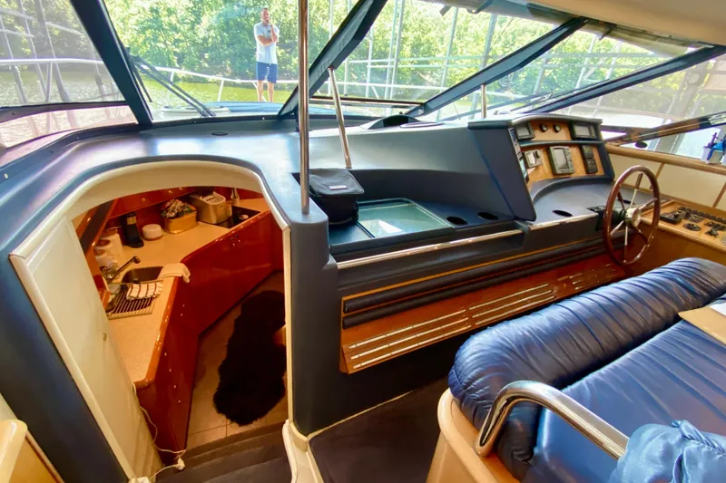 Slide: The Image of Interior of 1999 Neptunus 54 Hardtop Express yacht with helm and galley. - 35