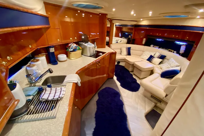 Slide: The Image of Luxurious interior of 1999 Neptunus 54 Hardtop Express yacht with elegant seating and kitchen area. - 43