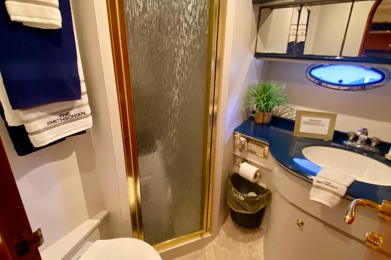 Slide: The Image of Luxurious bathroom in 1999 Neptunus 54 Hardtop Express yacht with shower and elegant decor. - 54