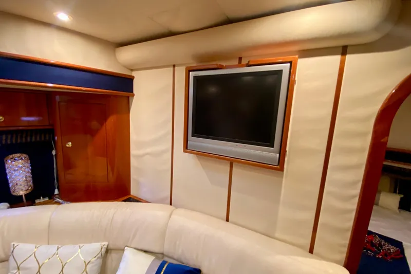 Slide: The Image of Luxurious interior of 1999 Neptunus 54 Hardtop Express yacht with TV and elegant decor. - 55