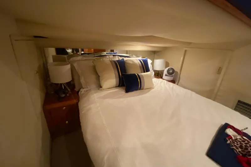 Slide: The Image of Cozy bedroom interior of 1999 Neptunus 54 Hardtop Express yacht with elegant bedding. - 59