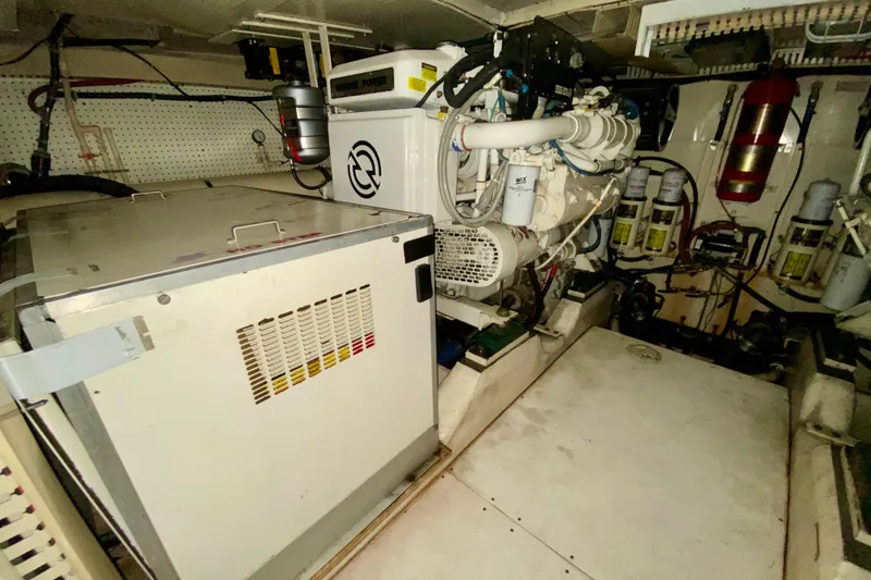 Slide: The Image of Engine room of 1999 Neptunus 54 Hardtop Express with visible machinery and equipment. - 69