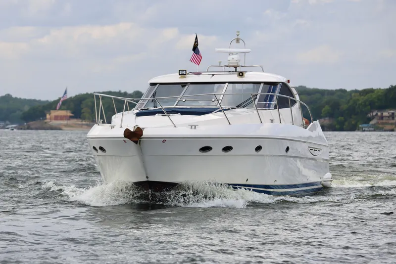Slide: The Image of 1999 Neptunus 54 Hardtop Express yacht cruising on a scenic waterway. - 7