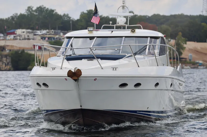 Slide: The Image of 1999 Neptunus 54 Hardtop Express yacht cruising on a scenic waterway. - 8