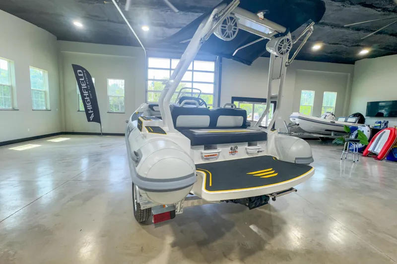 Slide: The Image of 2025 Highfield Velox 420 boat in showroom, rear view with modern design features. - 5