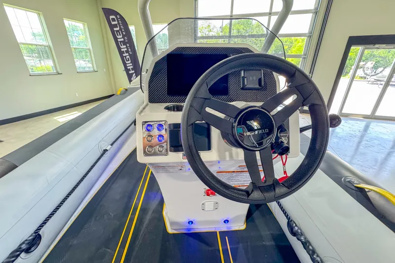 Slide: The Image of 2025 Highfield Velox 420 boat interior with steering wheel and control panel. - 9