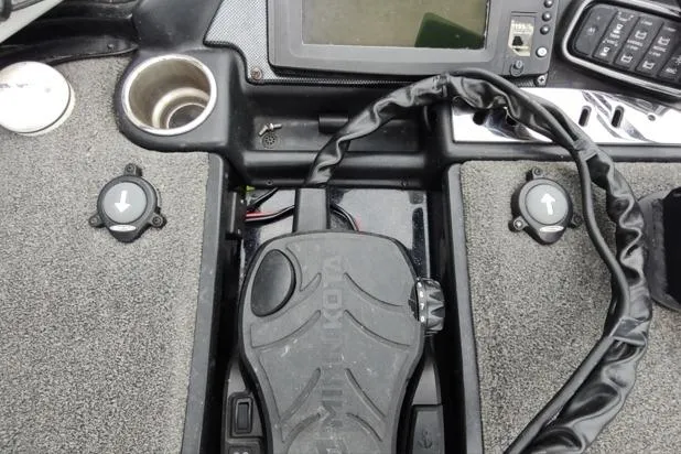Slide: The Image of 2015 Triton 21 TrX boat dashboard with control panel and foot pedal. - 6