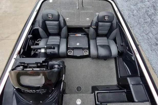 Slide: The Image of 2015 Triton 21 TrX boat interior with dual black seats and steering console. - 8
