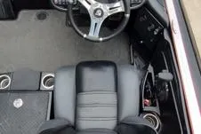 Slide: The Image of 2015 Triton 21 TrX boat interior with steering wheel and seating. - 9