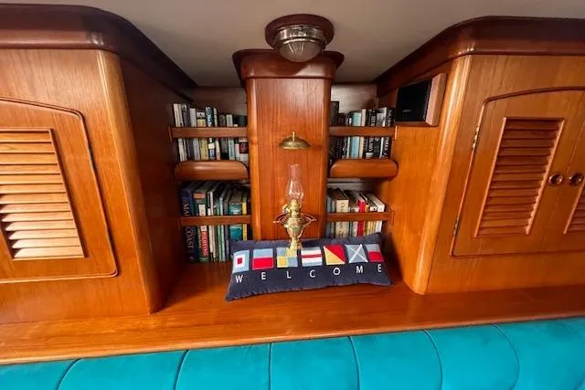 Slide: The Image of Wooden interior of 1986 Little Harbor AFt Cockpit K/CB Sloop with books and nautical decor. - 17