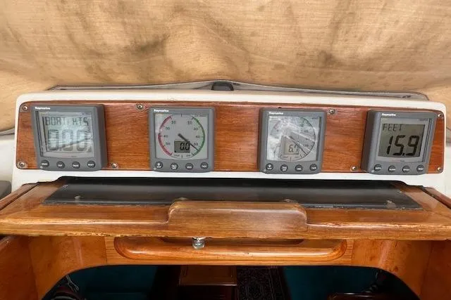 Slide: The Image of 1986 Little Harbor AFt Cockpit K/CB Sloop dashboard with navigation instruments and wooden paneling. - 33