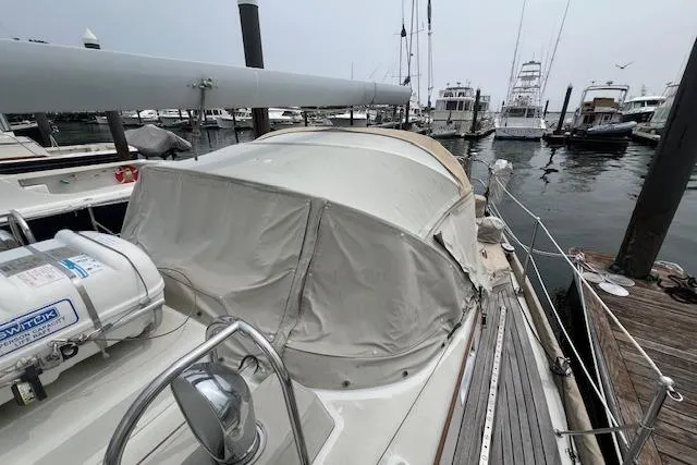 Slide: The Image of 1986 Little Harbor AFt Cockpit K/CB Sloop docked at marina, covered cockpit, overcast sky. - 36