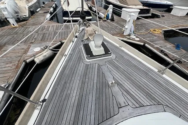 Slide: The Image of 1986 Little Harbor AFt Cockpit K/CB Sloop docked, showcasing teak deck and marina surroundings. - 38