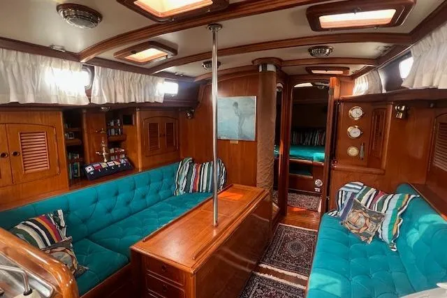 Slide: The Image of Luxurious 1986 Little Harbor AFt Cockpit K/CB Sloop interior with teal seating and wood accents. - 4