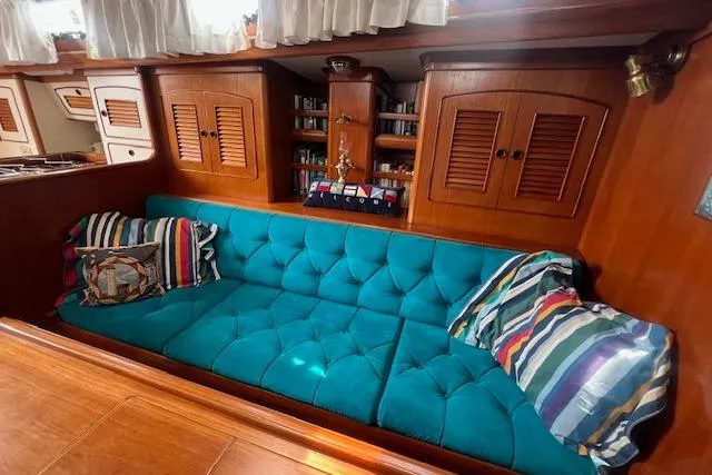 Slide: The Image of Luxurious 1986 Little Harbor AFt Cockpit Sloop interior with teal sofa and striped pillows. - 6
