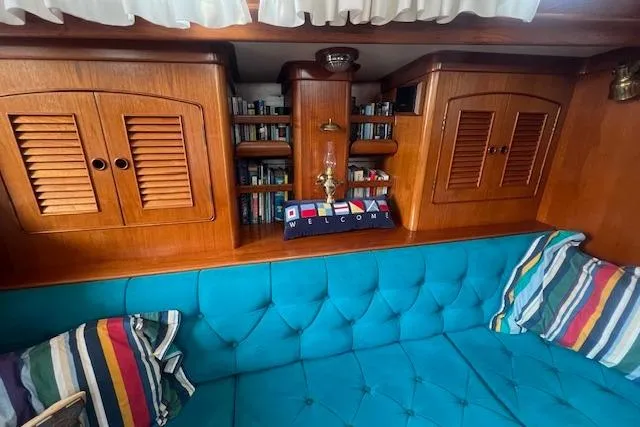 Slide: The Image of Interior of 1986 Little Harbor AFt Cockpit K/CB Sloop with wooden cabinets and blue seating. - 7