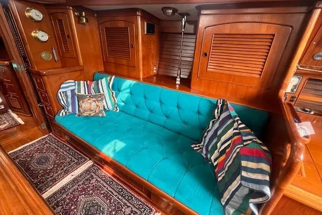 Slide: The Image of Luxurious 1986 Little Harbor AFt Cockpit Sloop interior with teal sofa and striped cushions. - 8