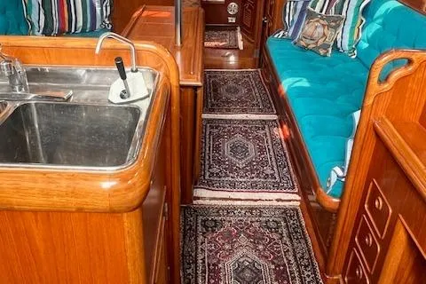 Slide: The Image of 1986 Little Harbor AFt Cockpit K/CB Sloop interior with wood finish and teal seating. - 9