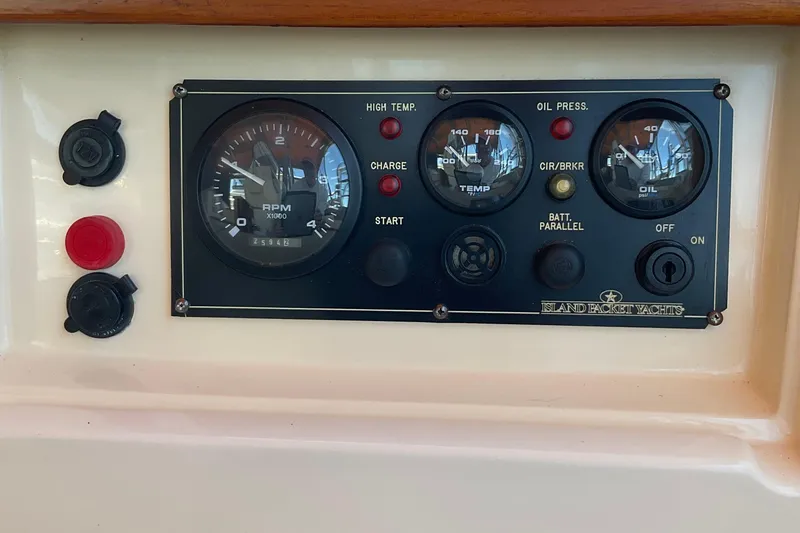 Slide: The Image of Instrument panel of a 2001 Island Packet 420 yacht, featuring gauges and controls. - 14