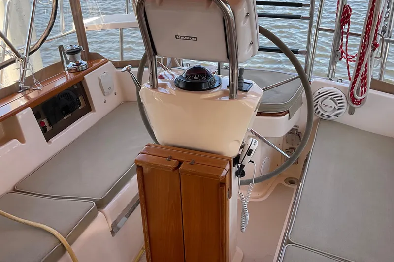 Slide: The Image of Interior view of 2001 Island Packet 420 sailboat cockpit with steering wheel and seating. - 16