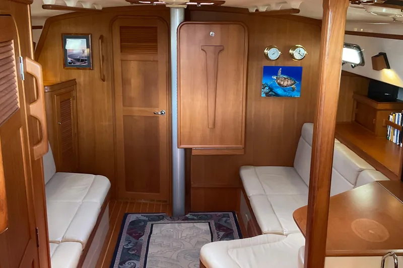 Slide: The Image of Interior of 2001 Island Packet 420 yacht with wooden finish and white seating. - 20