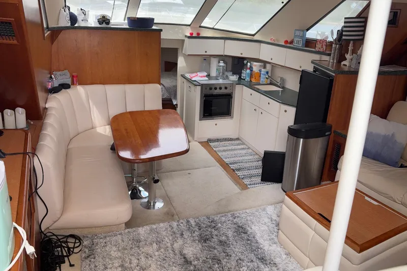 Slide: The Image of Interior of 1999 Silverton 392 yacht with kitchen and dining area. - 12