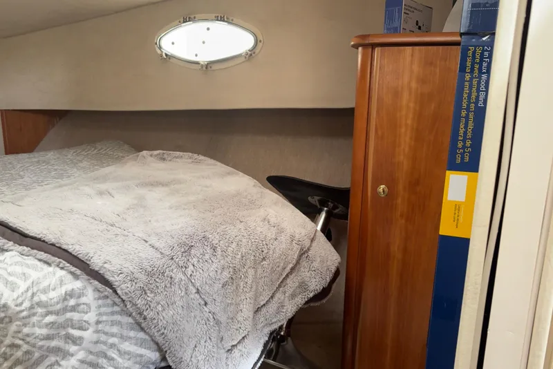 Slide: The Image of Cozy cabin interior of 1999 Silverton 392 with bed and wooden cabinet. - 21