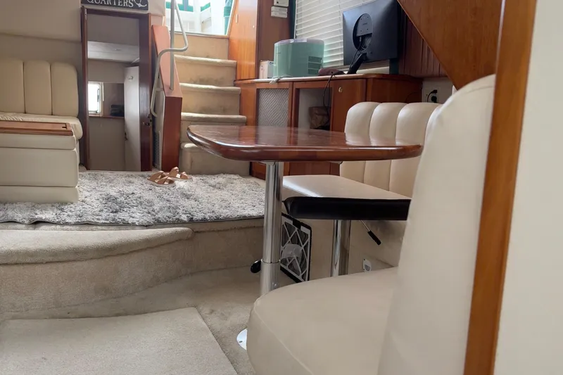 Slide: The Image of Interior of a 1999 Silverton 392 yacht with plush seating and wooden table. - 27