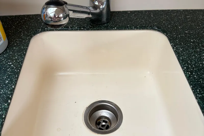 Slide: The Image of White sink with chrome faucet on speckled countertop, Silverton 392, 1999 model. - 28