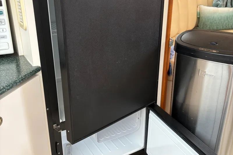 Slide: The Image of Open refrigerator in a 1999 Silverton 392 yacht kitchen area. - 30